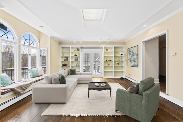 living room featuring a skylight, baseboard heating, wood finished floors, and french doors