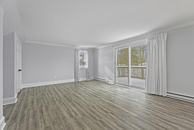 spare room featuring a baseboard radiator, crown molding, baseboards, and wood finished floors