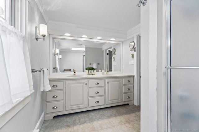 full bath with a sink, double vanity, and crown molding