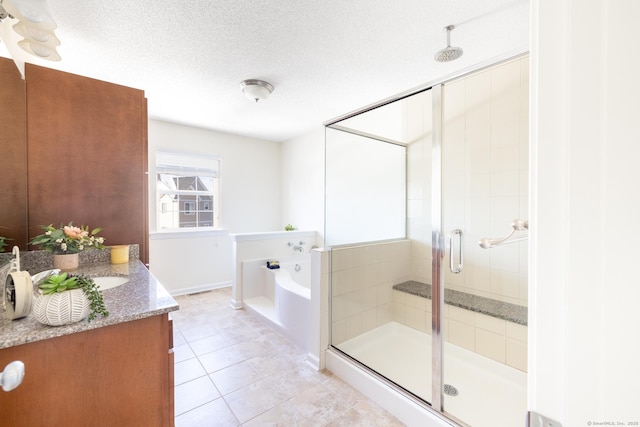 full bathroom with a textured ceiling, vanity, a shower stall, a bath, and tile patterned floors