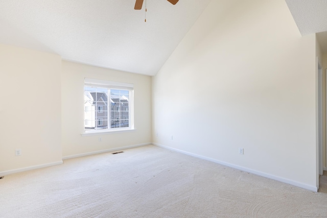 unfurnished room featuring baseboards, a ceiling fan, visible vents, and light colored carpet