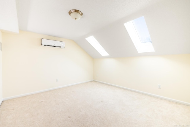 additional living space featuring light colored carpet, a wall mounted air conditioner, and baseboards