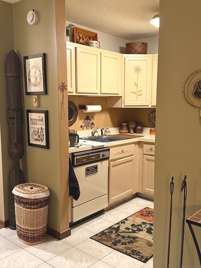 kitchen with dishwasher, sink, a textured ceiling, and light tile patterned floors