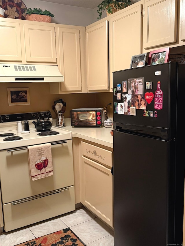 kitchen featuring range hood, white cabinets, light tile patterned flooring, white electric stove, and black fridge