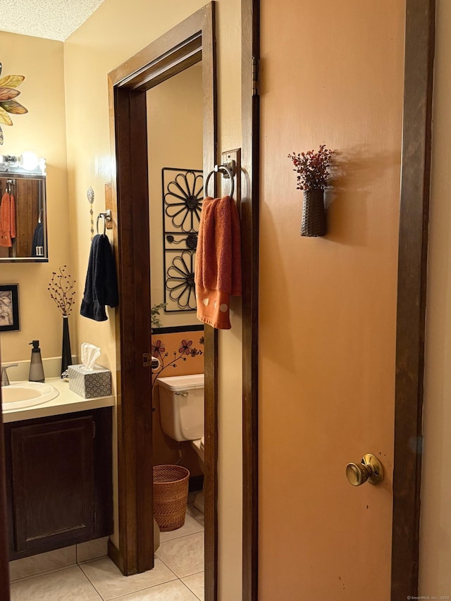 bathroom with vanity, toilet, and tile patterned flooring