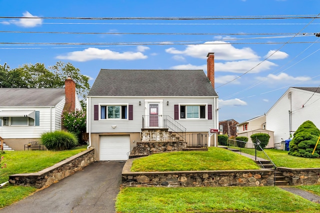 view of front of house with a garage and a front yard