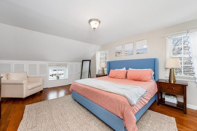 bedroom featuring dark hardwood / wood-style flooring and vaulted ceiling