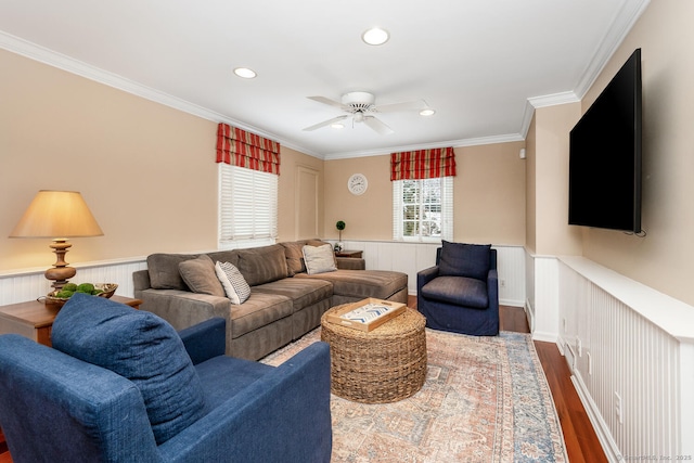 living room featuring ceiling fan, hardwood / wood-style flooring, and crown molding