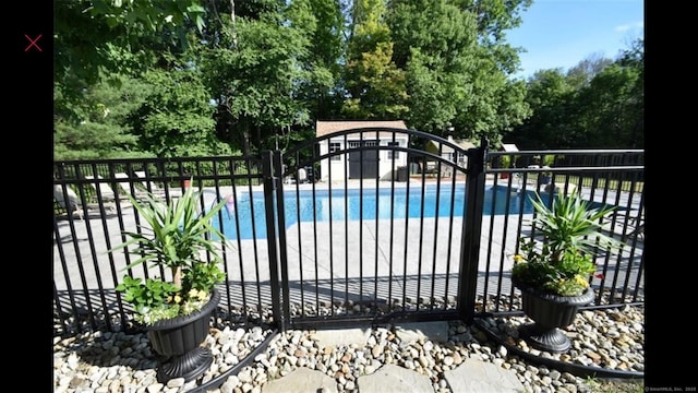 view of gate featuring a community pool