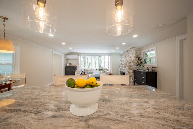 interior space with plenty of natural light, a fireplace, recessed lighting, and a wall mounted air conditioner