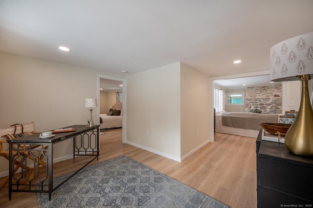 interior space featuring recessed lighting, baseboards, and wood finished floors