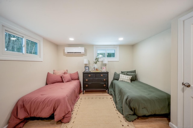 bedroom featuring a wall unit AC and recessed lighting