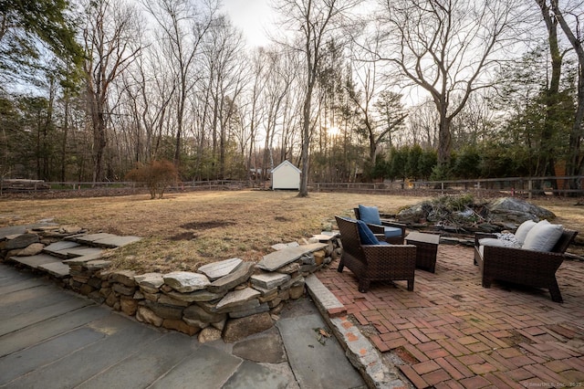 view of patio featuring a shed, an outdoor structure, and a fenced backyard