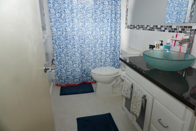 bathroom with tile patterned flooring, toilet, a shower with curtain, tile walls, and vanity