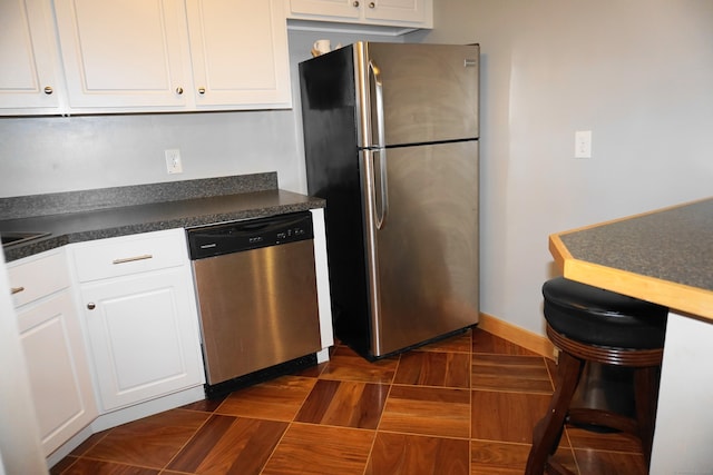 kitchen with appliances with stainless steel finishes and white cabinets