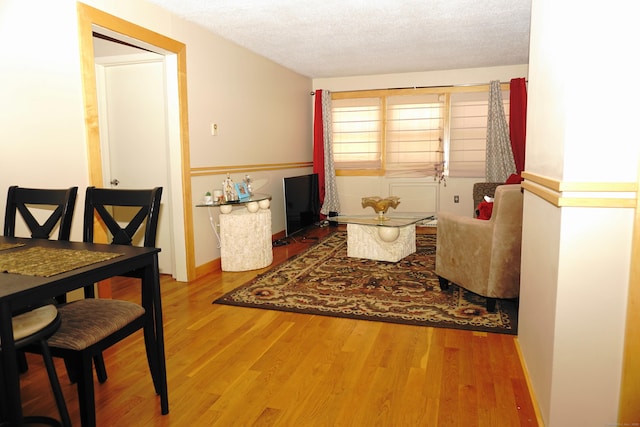 sitting room featuring hardwood / wood-style flooring and a textured ceiling