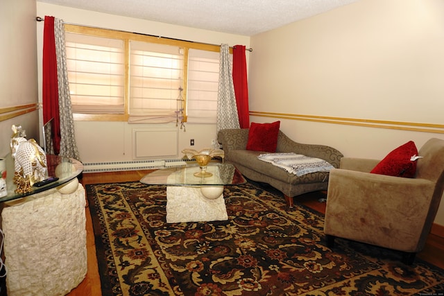 living room featuring dark hardwood / wood-style flooring, a textured ceiling, and a baseboard heating unit