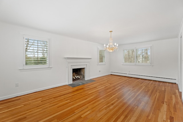 unfurnished living room with light hardwood / wood-style flooring, a fireplace, a notable chandelier, and a baseboard radiator