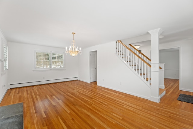 interior space featuring hardwood / wood-style flooring, a chandelier, decorative columns, and baseboard heating