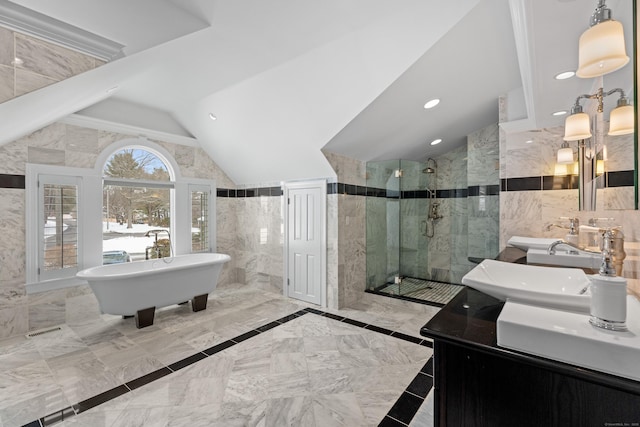 bathroom with lofted ceiling, independent shower and bath, tile walls, and vanity