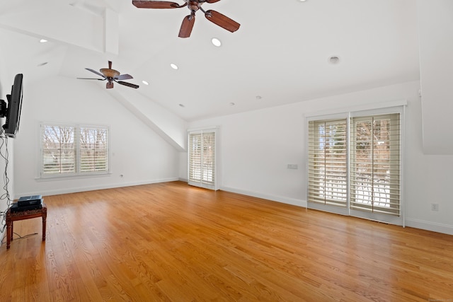 unfurnished living room featuring vaulted ceiling, ceiling fan, and light hardwood / wood-style flooring