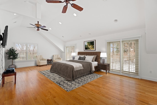 bedroom featuring ceiling fan, lofted ceiling, and light hardwood / wood-style floors