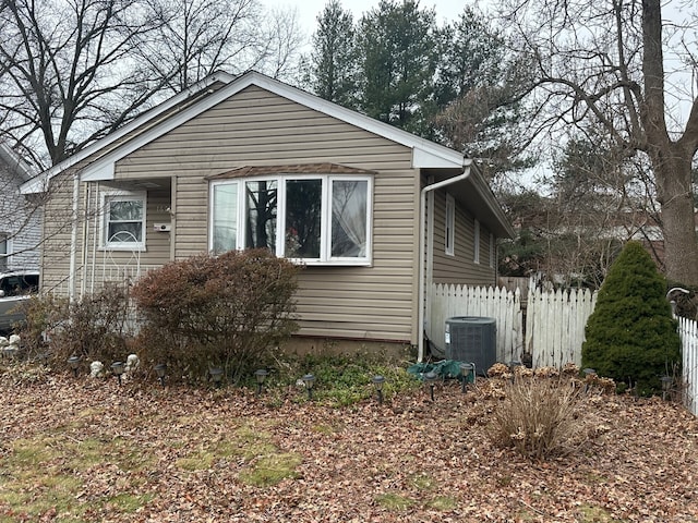 view of property exterior with fence and central air condition unit