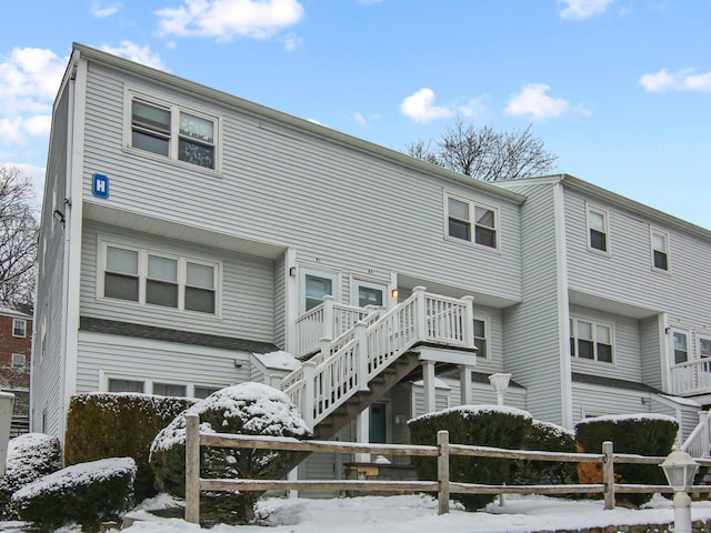 view of front of home featuring stairs and fence