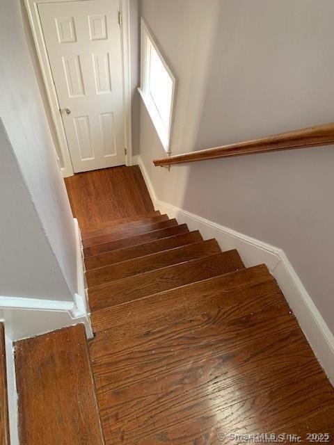 stairway with hardwood / wood-style floors