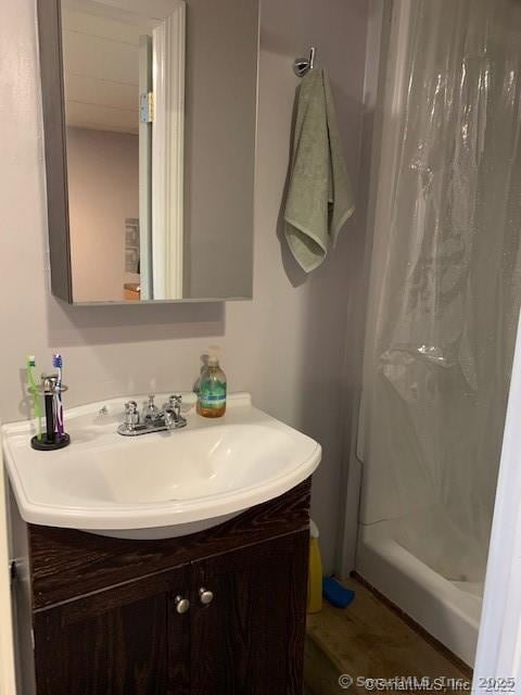 bathroom featuring vanity and curtained shower