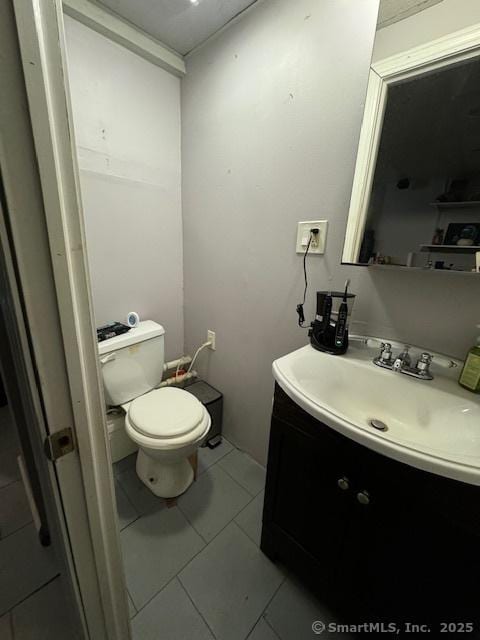 bathroom with vanity, tile patterned flooring, and toilet