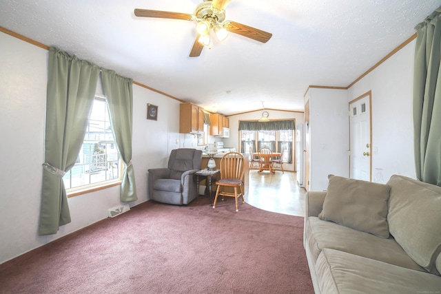 living area featuring carpet floors, visible vents, vaulted ceiling, and crown molding