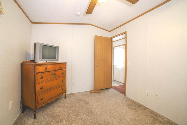 carpeted bedroom featuring ornamental molding, lofted ceiling, and ceiling fan