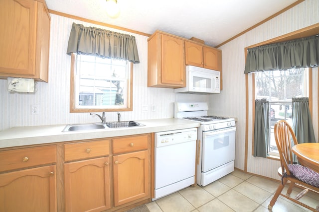 kitchen featuring wallpapered walls, light tile patterned floors, white appliances, light countertops, and a sink