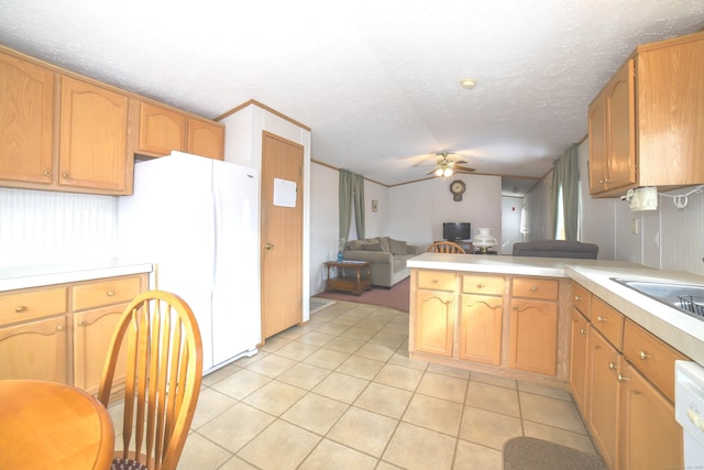 kitchen featuring light tile patterned flooring, a peninsula, a ceiling fan, open floor plan, and light countertops