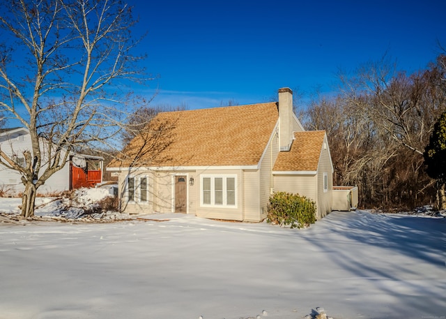 view of front of home featuring roof with shingles and a chimney