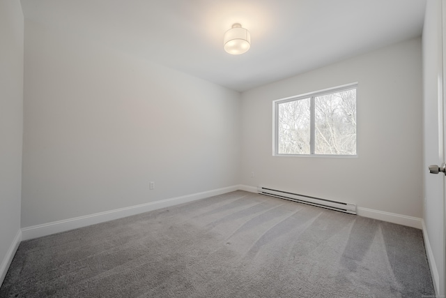 unfurnished room with carpet, a baseboard radiator, and baseboards