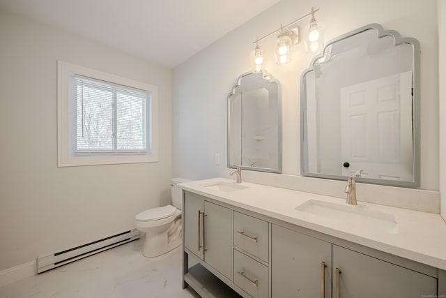 bathroom with marble finish floor, double vanity, baseboard heating, and a sink