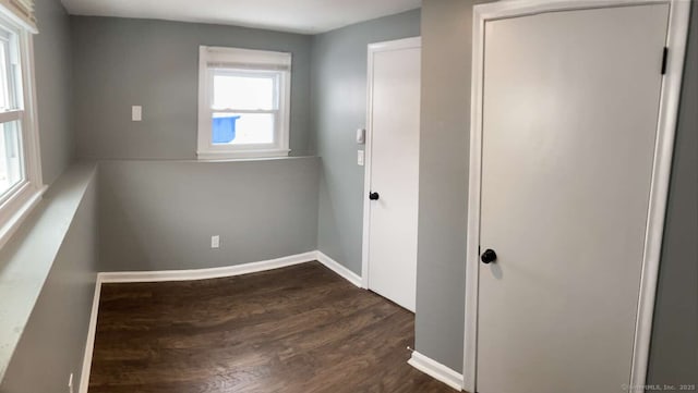 unfurnished bedroom featuring dark hardwood / wood-style flooring and a closet