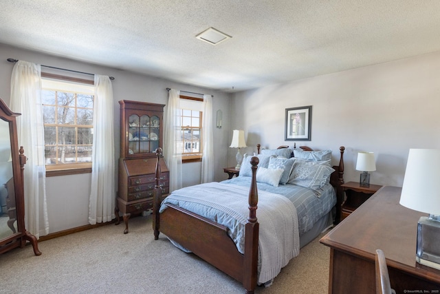 bedroom with light carpet, baseboards, and a textured ceiling