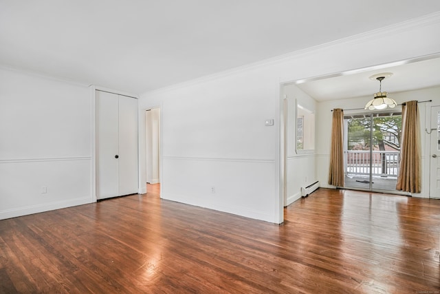 empty room with ornamental molding, dark hardwood / wood-style floors, and a baseboard heating unit