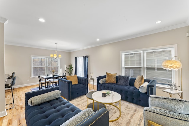 living area with recessed lighting, ornamental molding, a chandelier, light wood-type flooring, and baseboards