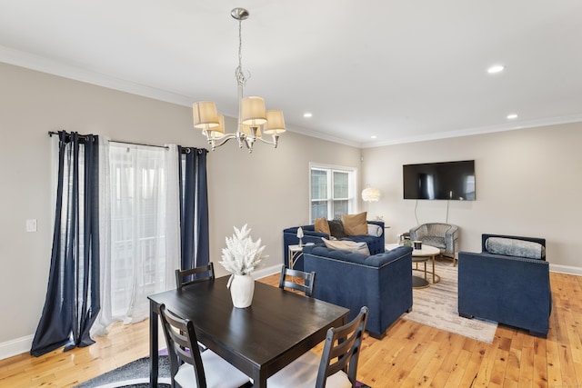 dining room with baseboards, light wood-type flooring, and crown molding