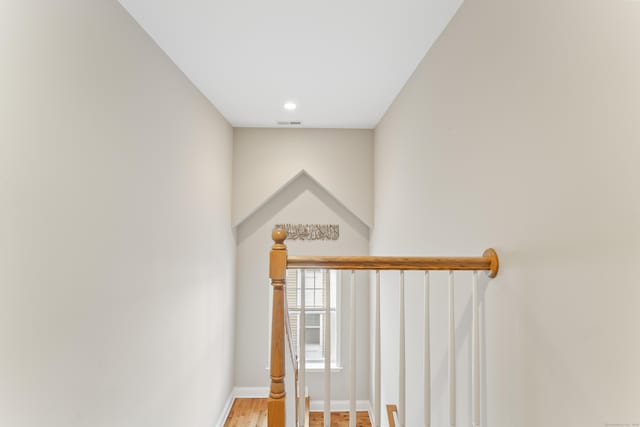 stairs with visible vents, baseboards, and wood finished floors