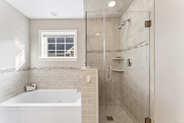 full bath with a garden tub and a shower stall