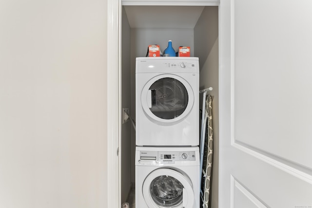 laundry room with stacked washer and dryer and laundry area