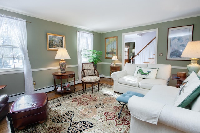 living room with hardwood / wood-style floors, a wealth of natural light, and crown molding