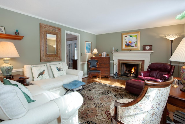 living room with ornamental molding, hardwood / wood-style flooring, and a brick fireplace