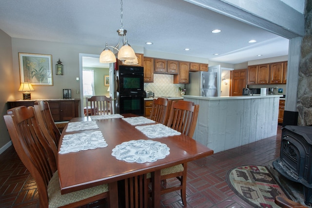 dining space featuring a wood stove