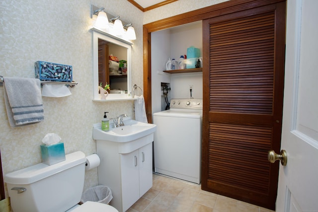 bathroom featuring washer / dryer, vanity, and toilet